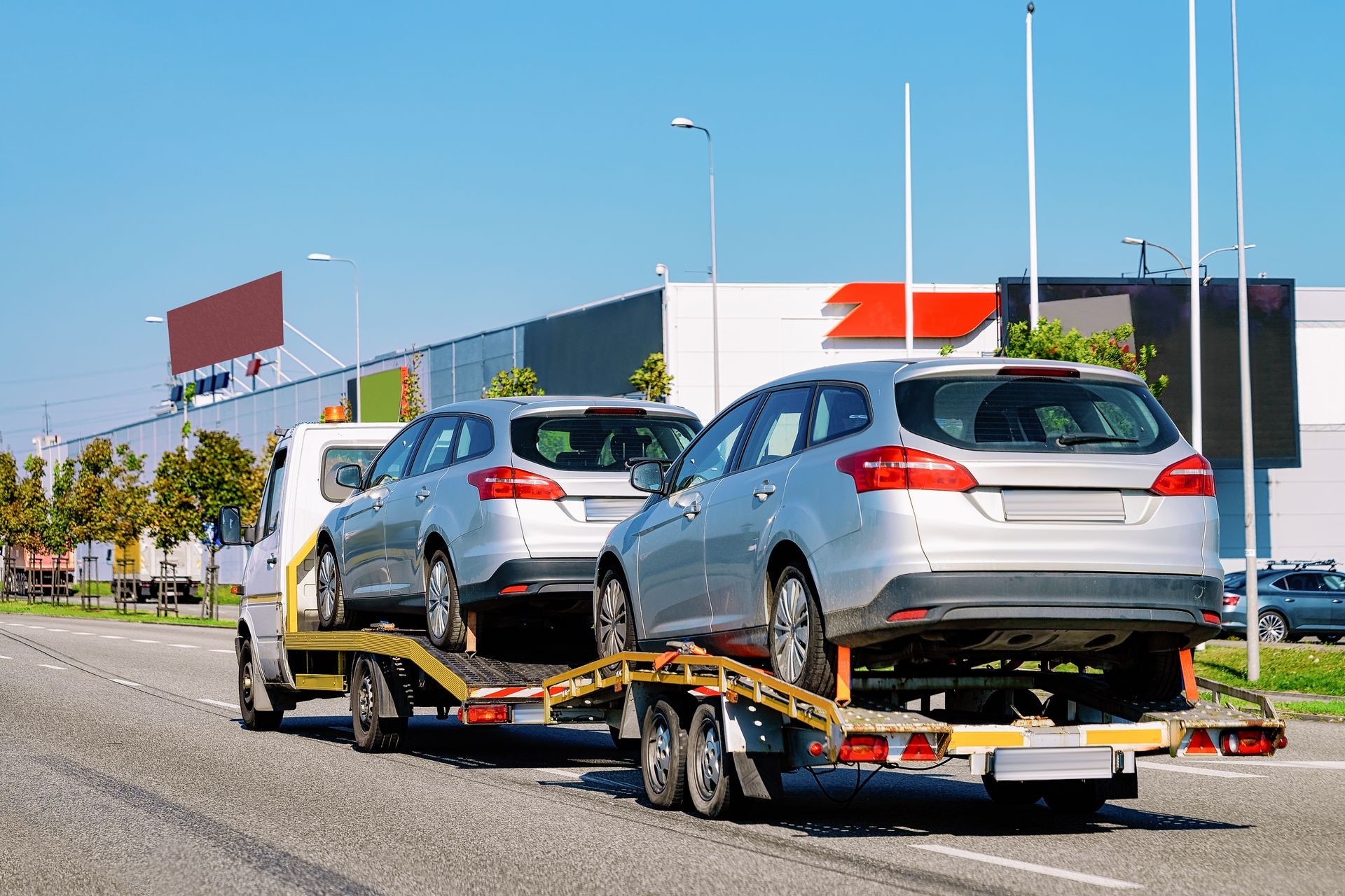 Car carrying trailer with new vehicles in the asphalt road in Slovenia.